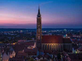 High angle view of illuminated buildings in town against sky