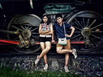 Portrait of young couple leaning on train