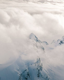 Scenic view of snow covered mountains against sky