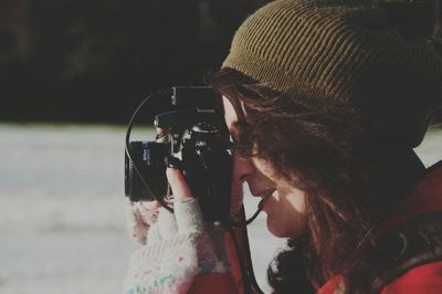 Side view of a female photographer