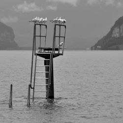 Lifeguard hut on sea against sky