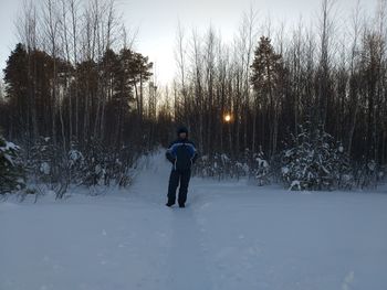 Rear view of man on snow covered land