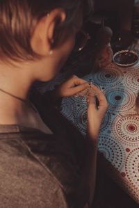 High angle view of woman sitting on bed at home