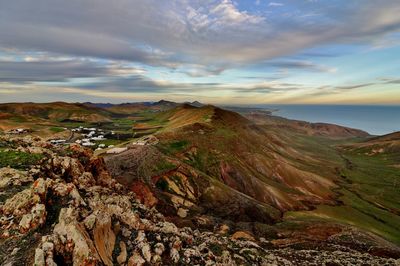 Scenic view of landscape against cloudy sky