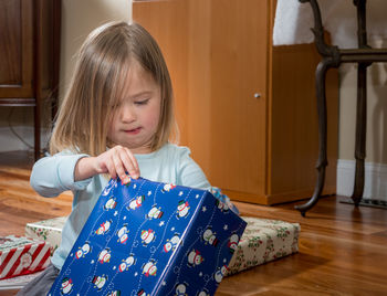 Girl holding camera at home