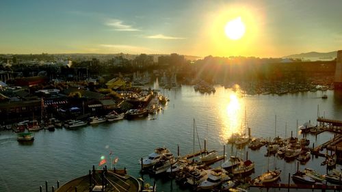 Harbor against sky during sunset