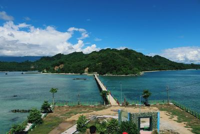 High angle view of bay against blue sky