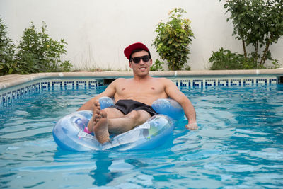 Portrait of shirtless man in swimming pool