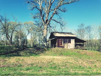 Abandoned house on field against sky