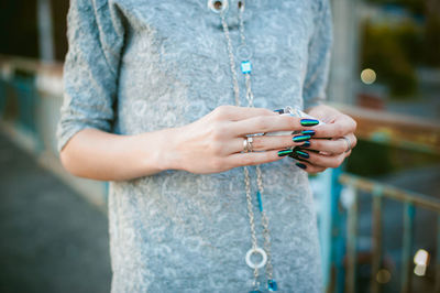 Midsection of woman holding cigarette