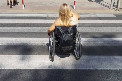 Rear view of woman walking on street