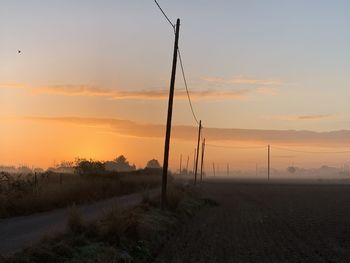 Scenic view of field against sky during sunset