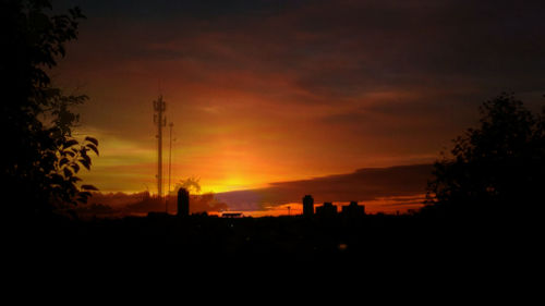 Scenic view of silhouette landscape against orange sky