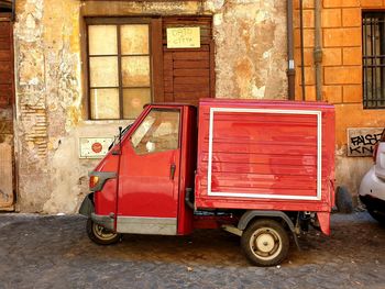 Vintage car on street against building