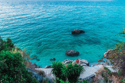 High angle view of rocks by sea