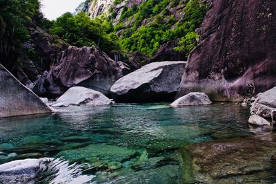 Rocks by sea against sky