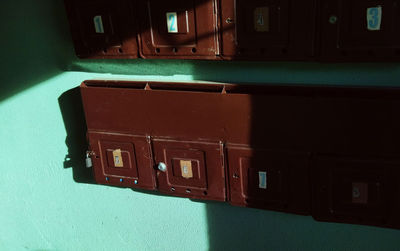 Close-up of telephone booth on table against wall