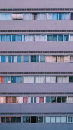 Full frame shot of apartment building purple, windows 