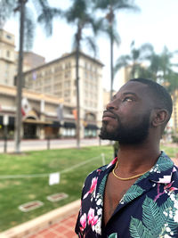 Portrait of young man looking away outdoors