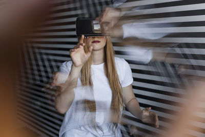 Girl gesturing wearing virtual reality headset