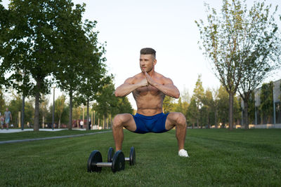 Rear view of man exercising in park