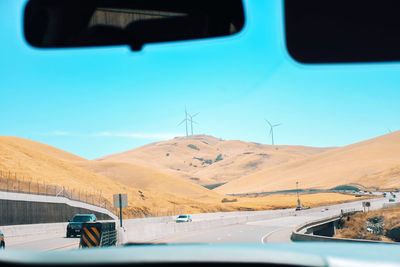 Road in mountains seen through car windshield