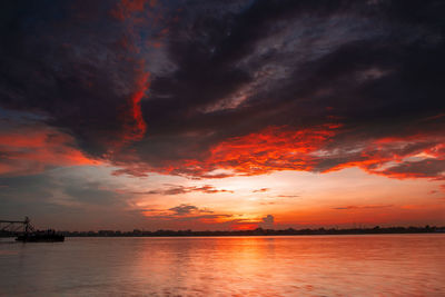 Scenic view of dramatic sky over sea during sunset