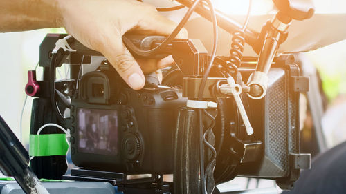 Cropped hand holding camera