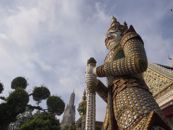 Low angle view of statue against building