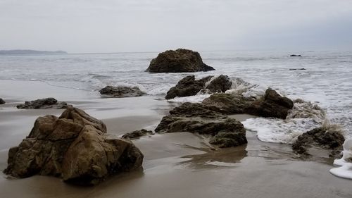 Rocks on shore against sky