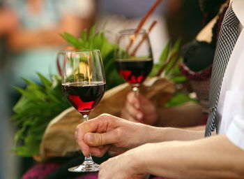 Cropped image of man holding wineglass