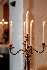 Close-up of illuminated candles against building