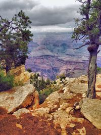 Scenic view of mountains against cloudy sky