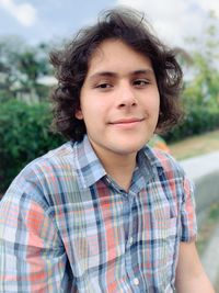 Portrait of smiling young man sitting outdoors