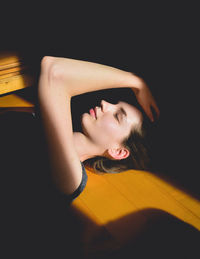 Portrait of beautiful woman against black background