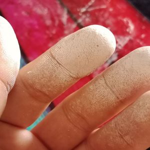 Close-up of hand holding red cake