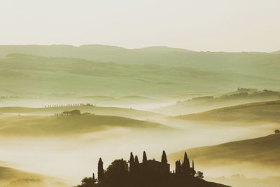 Sunrise with fog over a valley in tuscany - italy xi