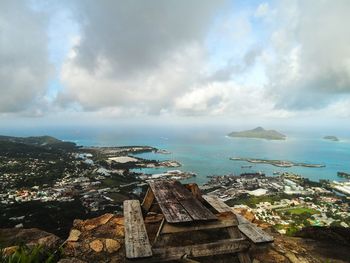 High angle view of cityscape by sea against sky