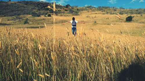 Rear view of man standing on field