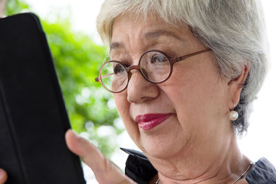 Close-up of woman using mobile phone