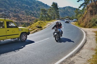 People riding motorcycle on street