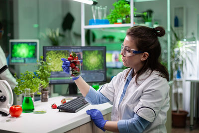 Rear view of woman working on table