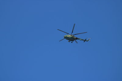 Low angle view of airplane against clear blue sky