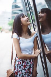 Beautiful young woman standing in city