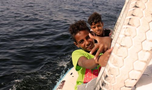 Portrait of father and son standing in sea