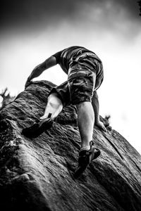 Low angle view of man on rock