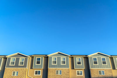 Low angle view of buildings against blue sky