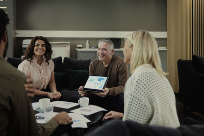 Group of business people having meeting in lobby