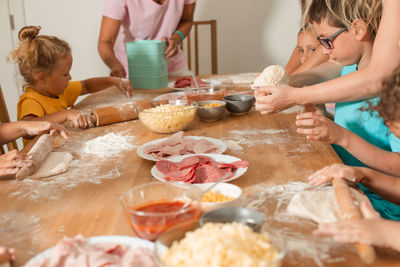 Rear view of women preparing food