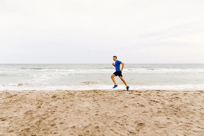 Full length of man on beach against sky